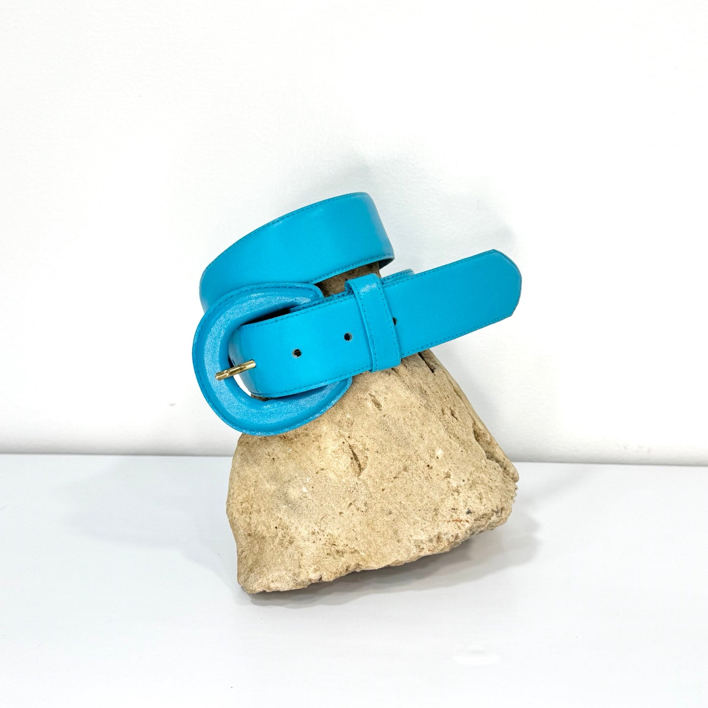 Vintage Fob Trading turquoise blue leather belt styled on stone